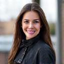 Portrait of Chloe Watson, a rider with vibrant hair and a motorcycle jacket.